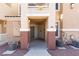 Inviting townhome entrance with covered walkway and neutral color scheme at 5855 Valley Dr # 1107, North Las Vegas, NV 89031
