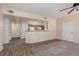 Open living space with wood floors flowing into carpeted living room and adjacent kitchen at 5855 Valley Dr # 1107, North Las Vegas, NV 89031