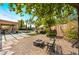 Outdoor area with a fire pit, a bench, a covered patio, and a view of the pool and well-manicured landscaping at 5872 Revital Ct, Las Vegas, NV 89131