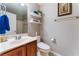 Stylish powder room featuring floating shelves, floral wall art, and a modern elongated toilet at 5872 Revital Ct, Las Vegas, NV 89131