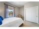 Bright bedroom featuring tile floor, closet, window with curtains, and a comfortable chair at 5872 Revital Ct, Las Vegas, NV 89131