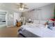 Cozy bedroom with a ceiling fan, vanity, desk, decorative wall art, and soft plush accents at 5872 Revital Ct, Las Vegas, NV 89131