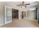 Bright bonus room with ceiling fan, double doors, and mirror wall reflecting the entry to the second floor at 5872 Revital Ct, Las Vegas, NV 89131