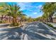 Gated community entrance with mature trees and lush landscaping at 5872 Revital Ct, Las Vegas, NV 89131
