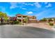 Charming two-story home featuring a balcony, three-car garage, and well-manicured landscaping at 5872 Revital Ct, Las Vegas, NV 89131