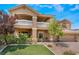 Inviting two-story home featuring a balcony, three-car garage, and a lush lawn at 5872 Revital Ct, Las Vegas, NV 89131