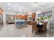 Open kitchen with a large island, breakfast bar seating and adjacent dining area featuring modern decor at 5872 Revital Ct, Las Vegas, NV 89131