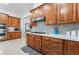 Modern kitchen featuring a gas range, white countertops, wooden cabinetry, and stylish backsplash at 5872 Revital Ct, Las Vegas, NV 89131