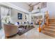 Elegant living room featuring soaring ceilings, an open floor plan, and a staircase at 5872 Revital Ct, Las Vegas, NV 89131