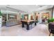 Spacious living room featuring a pool table, comfortable seating, and seamless indoor-outdoor flow at 5872 Revital Ct, Las Vegas, NV 89131