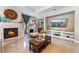 Inviting living room with a cozy fireplace, stylish decor, and a large screen television for entertainment at 5872 Revital Ct, Las Vegas, NV 89131