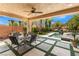 Covered outdoor space featuring a dining table with chairs and a lounge area overlooking the pool and backyard at 5872 Revital Ct, Las Vegas, NV 89131