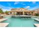 Beautiful pool with bar stools, integrated fountains and views of the home's architecture and covered outdoor living areas at 5872 Revital Ct, Las Vegas, NV 89131