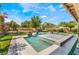 Beautiful pool with a built-in spa and lovely landscaping surrounded by comfortable outdoor seating and green lawn space at 5872 Revital Ct, Las Vegas, NV 89131