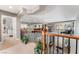 Second floor view of open landing and living spaces with railing overlooking the entry at 5872 Revital Ct, Las Vegas, NV 89131