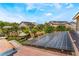 Roof view showcases installed solar panels on a tile roof with a beautiful backyard and blue skies at 5872 Revital Ct, Las Vegas, NV 89131