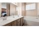 Bright bathroom features double sinks, a large mirror, and a soaking tub for relaxation at 5934 Reflection Point Ct, Las Vegas, NV 89110