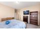 Bedroom showcasing a wooden bed frame, and TV, offering a relaxing space at 5934 Reflection Point Ct, Las Vegas, NV 89110