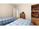 Simple bedroom with two twin beds, a dresser, and an enclosed closet at 5934 Reflection Point Ct, Las Vegas, NV 89110