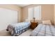 Cozy bedroom featuring two twin beds with matching blue and white bedding and a nightstand between them at 5934 Reflection Point Ct, Las Vegas, NV 89110