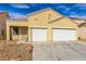 Single-story home with a two-car garage, desert landscaping, and a blue sky overhead at 5934 Reflection Point Ct, Las Vegas, NV 89110
