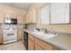 Kitchen featuring stainless steel appliances, tile floors, and a light colored countertops at 5934 Reflection Point Ct, Las Vegas, NV 89110
