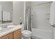 Well-lit bathroom with shower over tub, framed mirror and light wood vanity at 6059 Saddle Horse Ave, Las Vegas, NV 89122