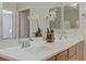 Bright bathroom featuring double sinks, modern fixtures, and a view of the main bedroom at 6059 Saddle Horse Ave, Las Vegas, NV 89122