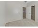 Bright bedroom with neutral tones features an ensuite bathroom and carpeted floors at 6059 Saddle Horse Ave, Las Vegas, NV 89122