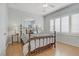Sunlit bedroom with a metal bed frame, ceiling fan, and bright windows with plantation shutters at 6059 Saddle Horse Ave, Las Vegas, NV 89122