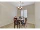 Cozy dining area featuring a chandelier, four-person dining table, and natural light from a nearby window at 6059 Saddle Horse Ave, Las Vegas, NV 89122