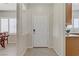 Welcoming entryway featuring neutral colors, tile flooring, and a view of the dining and kitchen areas at 6059 Saddle Horse Ave, Las Vegas, NV 89122