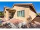 The exterior of the property reveals a covered patio and neatly landscaped surroundings at 6059 Saddle Horse Ave, Las Vegas, NV 89122