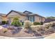 Landscaped front yard showcasing desert landscaping, mature plants, and charming facade of a single-story home at 6059 Saddle Horse Ave, Las Vegas, NV 89122