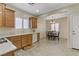 Bright kitchen featuring wood cabinets, light countertops, stainless steel appliances, and a cozy dining area at 6059 Saddle Horse Ave, Las Vegas, NV 89122