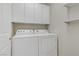 A pristine laundry room provides the convenience of a full-sized washer and dryer at 6059 Saddle Horse Ave, Las Vegas, NV 89122