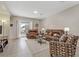 Comfortable living area with a sliding glass door to the patio, a decorative rug, and a plush leather sofa and love seat at 6059 Saddle Horse Ave, Las Vegas, NV 89122