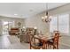 Inviting living room and dining area with plantation shutters, tile floors, comfortable seating, and a view to the exterior patio at 6059 Saddle Horse Ave, Las Vegas, NV 89122