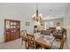 Open concept living and dining area with an entertainment center, sliding doors, and a traditional china cabinet at 6059 Saddle Horse Ave, Las Vegas, NV 89122