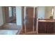 Bathroom with separate tub and shower, paired with granite counters and wood cabinets at 6120 Matisse Ave, Las Vegas, NV 89131