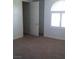 Bedroom with carpet, window with shutters, and a door leading to another room at 6120 Matisse Ave, Las Vegas, NV 89131