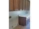 Laundry room with upper and lower cabinets, laminate countertops and tile flooring at 6120 Matisse Ave, Las Vegas, NV 89131