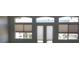 View of the wall with windows and doors with neutral colored cellular shades at 6120 Matisse Ave, Las Vegas, NV 89131