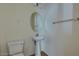 A compact powder room featuring a pedestal sink, oval mirror, tile floors and neutral wall paint at 6134 Pine Villa Ave # 103, Las Vegas, NV 89108