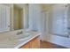 Bright bathroom featuring a shower, vanity, mirror, and tan tile flooring at 6134 Pine Villa Ave # 103, Las Vegas, NV 89108