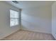 Cozy carpeted bedroom with natural light from the window, and white walls at 6134 Pine Villa Ave # 103, Las Vegas, NV 89108