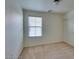A cozy bedroom with carpeted floors, neutral walls, closet, and a window for natural light at 6134 Pine Villa Ave # 103, Las Vegas, NV 89108