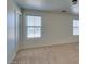 Spacious bedroom featuring neutral carpet, two windows and white walls at 6134 Pine Villa Ave # 103, Las Vegas, NV 89108