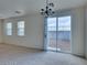 An open layout dining space with a view of the backyard, featuring a neutral color scheme at 6134 Pine Villa Ave # 103, Las Vegas, NV 89108