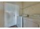 A laundry room featuring tile floors, washer and dryer and a door to the exterior of the home at 6134 Pine Villa Ave # 103, Las Vegas, NV 89108